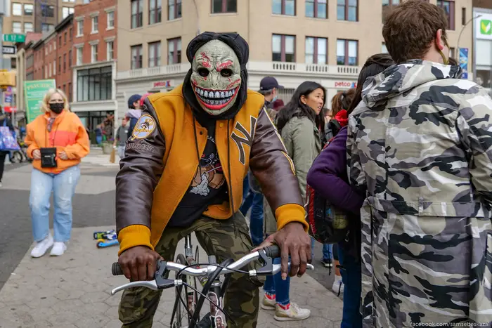 a guy in a mask and a Yankees jacket at the Halloween parade